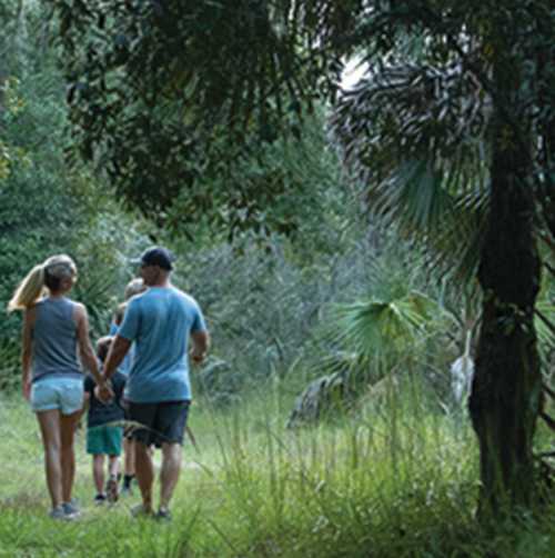 A family hikes along a trail