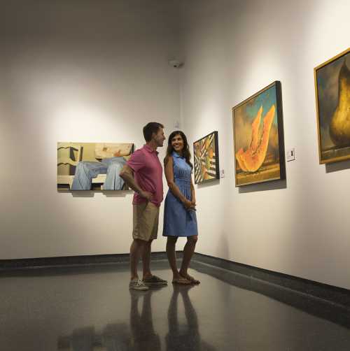 A couple views an art exhibit at a Daytona Beach museum.