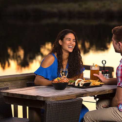 A couple is enjoying a sunset dinner on the Tomoka River