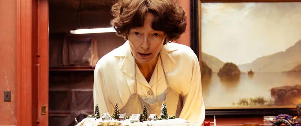 Female actor overlooking a table display
