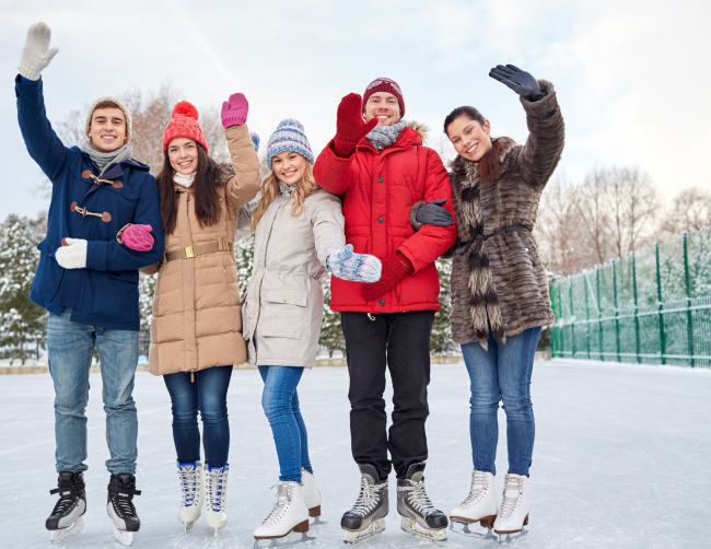 5 people wearing winter clothes and skates on ice