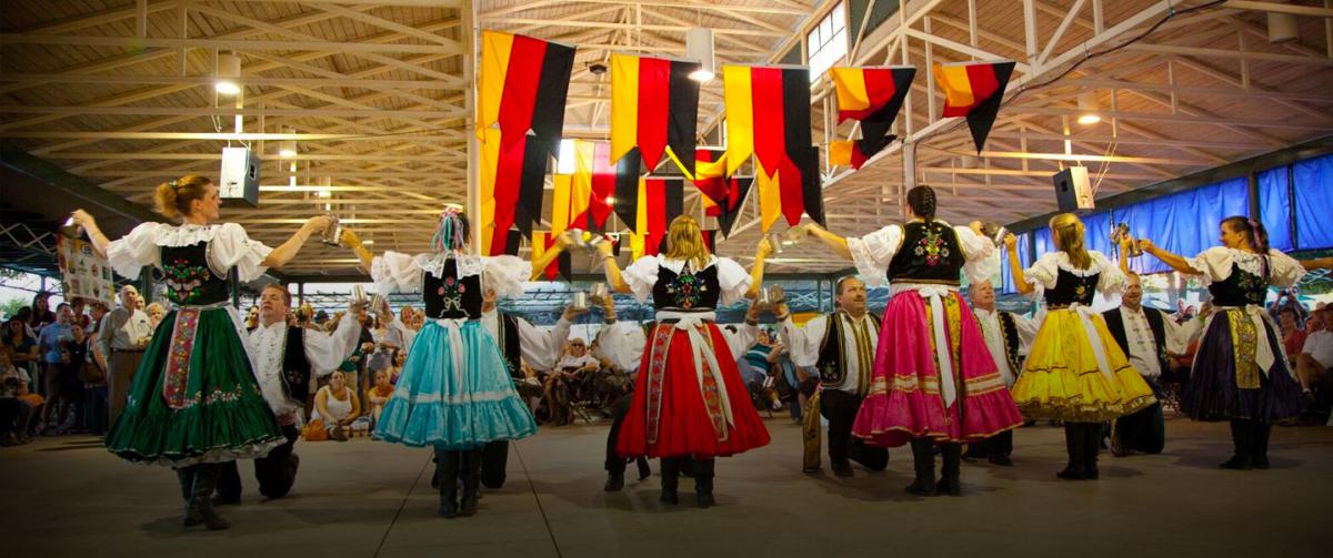 Group of people in German attire dancing.