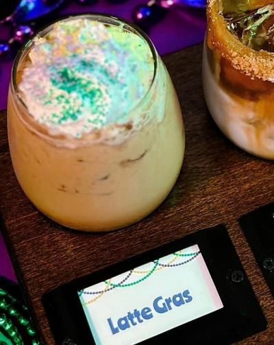 latte gras topped with whipped cream and sprinkles from village coffehouse