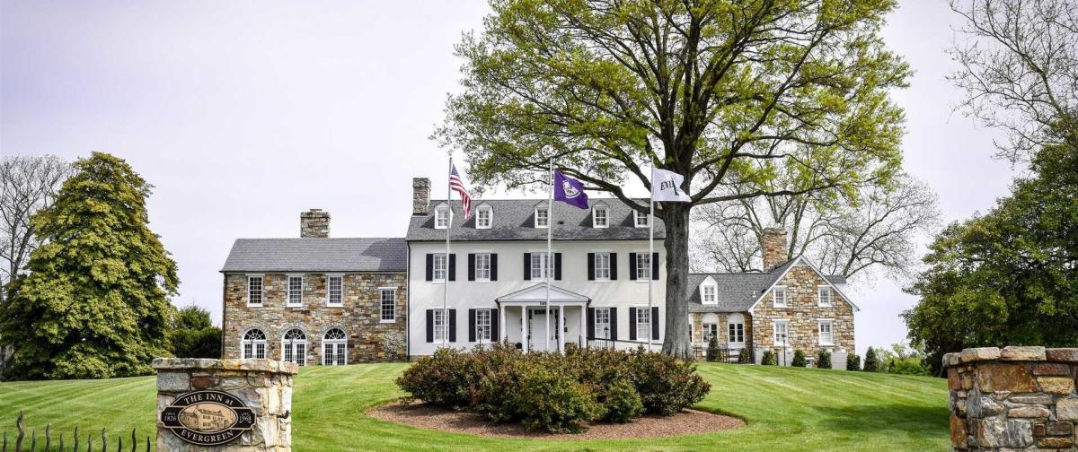 exterior view of The Inn at Evergreen front lawn and manor