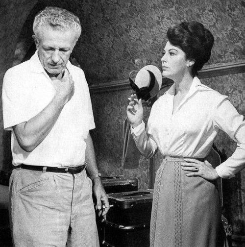 Director Nicholas Ray standing on set with Ava Gardner