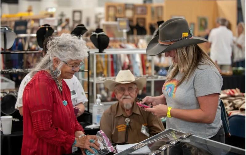 Someone shops at a booth during the Great Southwestern Antique Show.