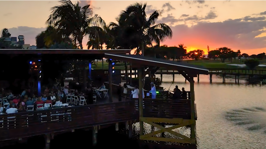 A golden hour view of the Deck @ Galuppi's as the sun sets over the Pompano Beach Golf Course.