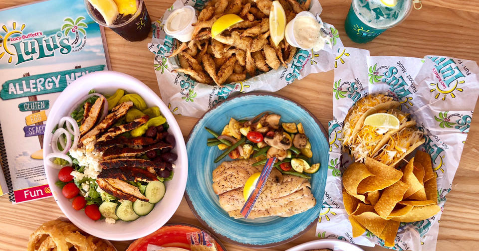 A table full of a variety of food and a menu at Lucy Buffett’s ‘LuLu’s’ in North Myrtle Beach
