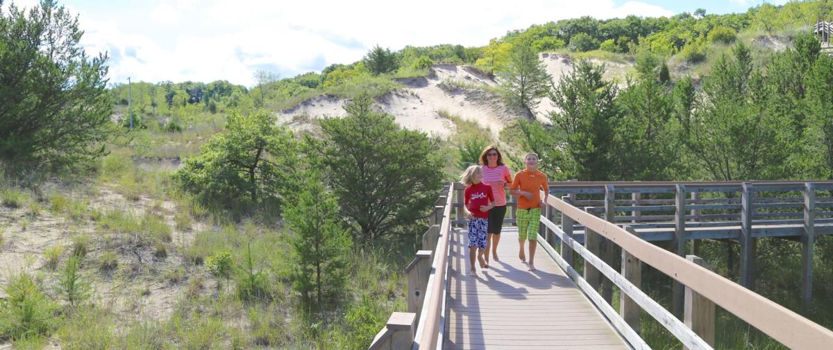 Family walking to the beach through the Dunes