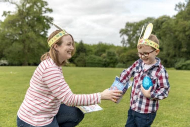a woman and a child wearing easter bunny ears at buckfast abbey