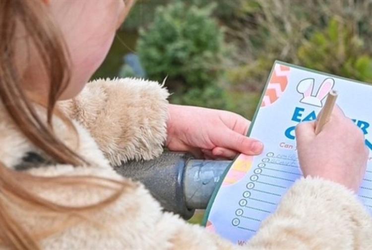 Child filling in an Easter Egg Hunt trail sheet