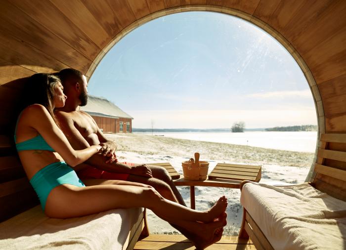 Couple sitting in Barrel Sauna overlooking Canandaigua Lake