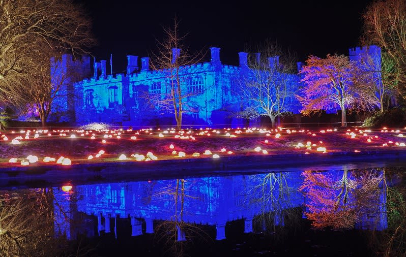 Sudeley Castle bathed in blue light is reflected in the lake
