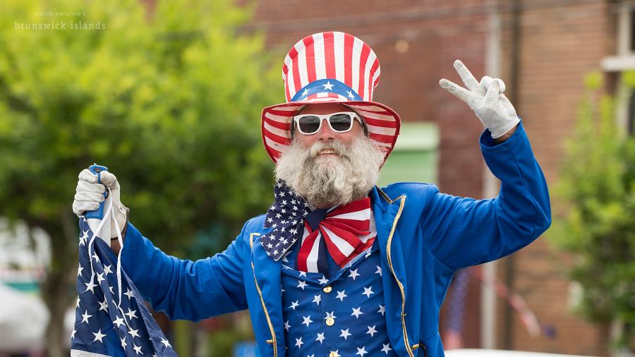 a man dressed up in a red, white, and blue USA outfit for the NC 4th of July Festival parade in Southport, NC