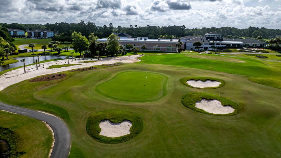 an aerial view of a golf course green and clubhouse at the Byrd Course at Sea Trail Golf Resort