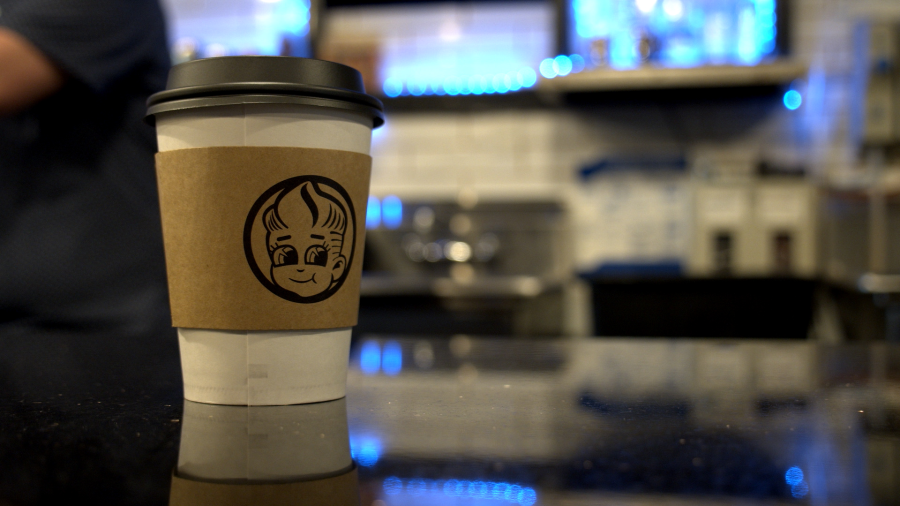 A Coffee sits on the counter at Golden Boy Coffee