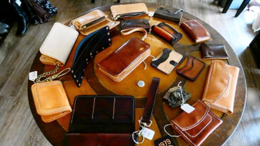 A table full of leather wallets and purses