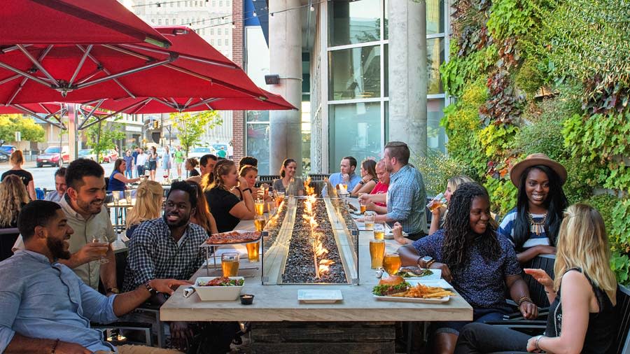 People Eating At The Tap patio