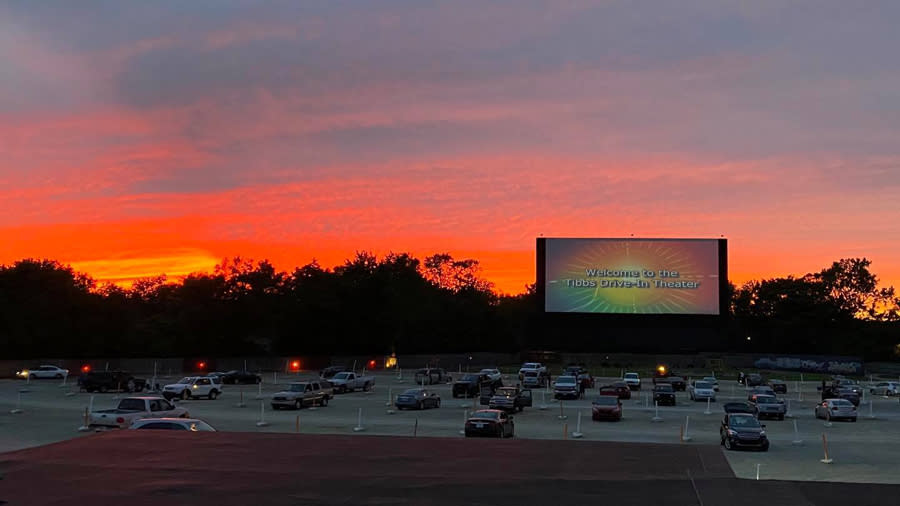 Sunset sky with the drive-in theatre with cars