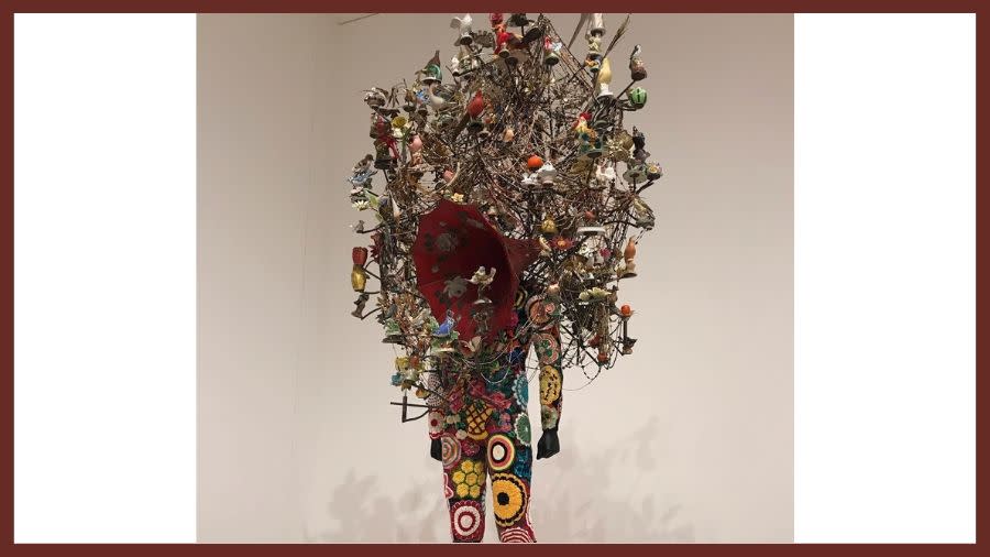 An image of a colorful, magnetic sculpture of a human being. The top of the sculpture reaches out over the edges to create an impressive hood of interlinking metal parts