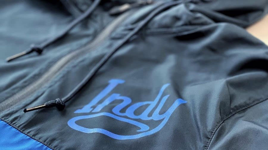 indy-branded windbreaker closeup of logo, blue and navy color