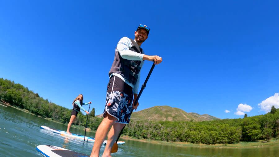 man on stand up paddle board at Maple Lake