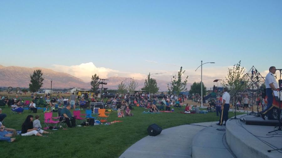 Saratoga Springs Neptune Park audience gathered by stage in camping chairs