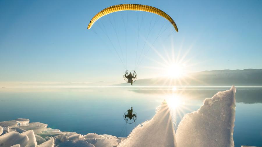 Man paragliding over Utah Lake