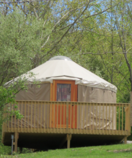 photo of yurt at aj jolly park in Alexandria ky with green trees and green grass in springtime