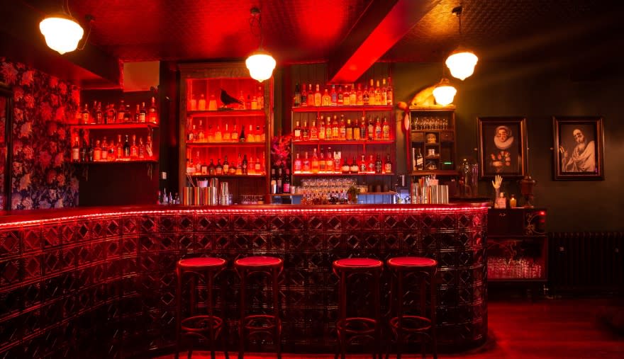 The bar at The Raven Bristol with red lights