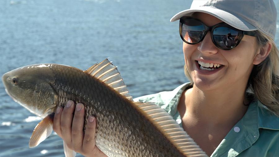 woman holding a fish