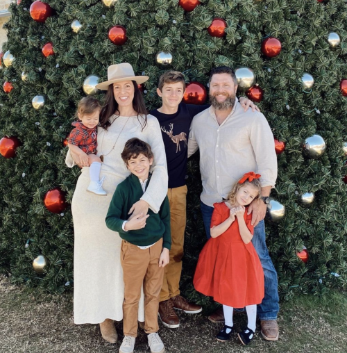 family in front of Christmas tree