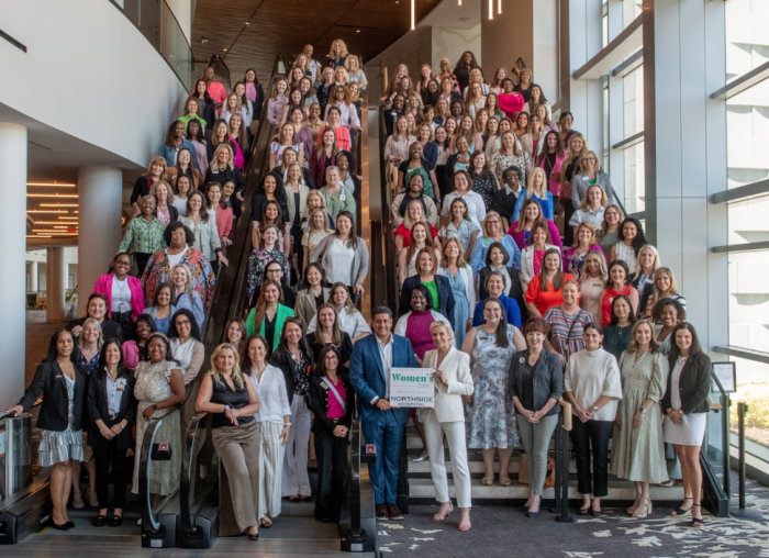 Group of 50-60 professional women at Gas South District on a staircase