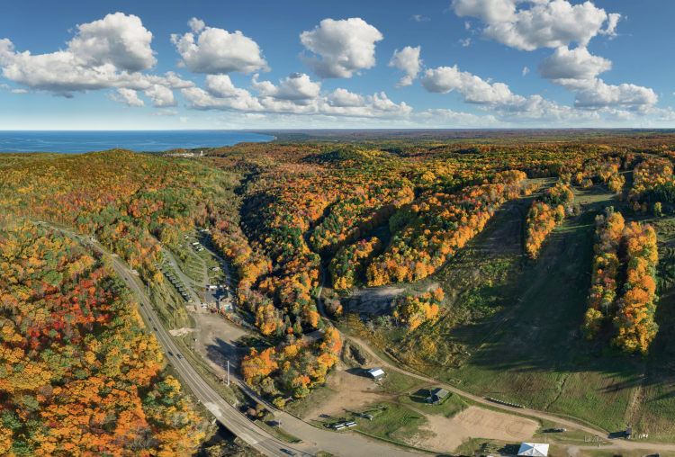 An aerial view of Rippling River campground during peak fall color near Lake Superior in Marquette, Michigan.