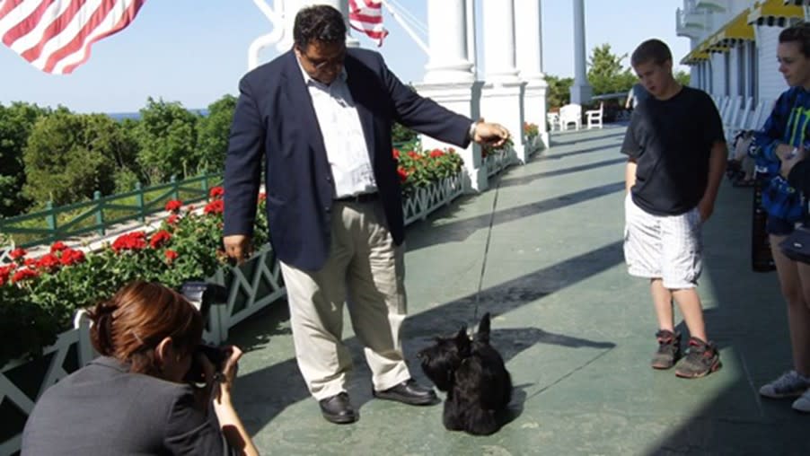 Sadie the Scottish terrier dog show champion is walked on the front porch of Mackinac Island’s Grand Hotel