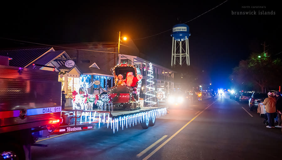a mr. and mrs. claus on a parade float in Southport, NC