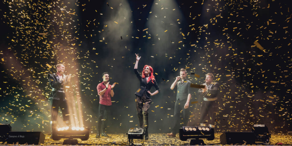 Five people perform magic tricks on stage during "Champions of Magic"