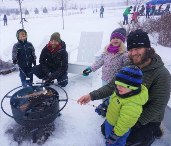 Kids roasting marshmallows during a snowy winter