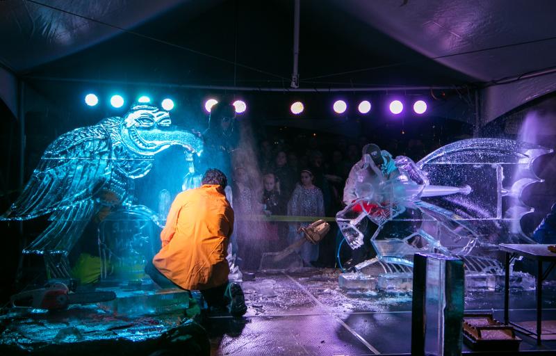 Two ice sculptors carving for a live audience for the Freezefest Ice Battle
