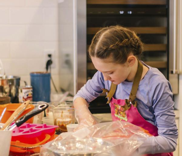 Girl baking at the Mesa Kids Cooking School in New Albany, IN