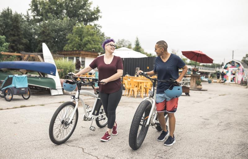 women walking their bikes