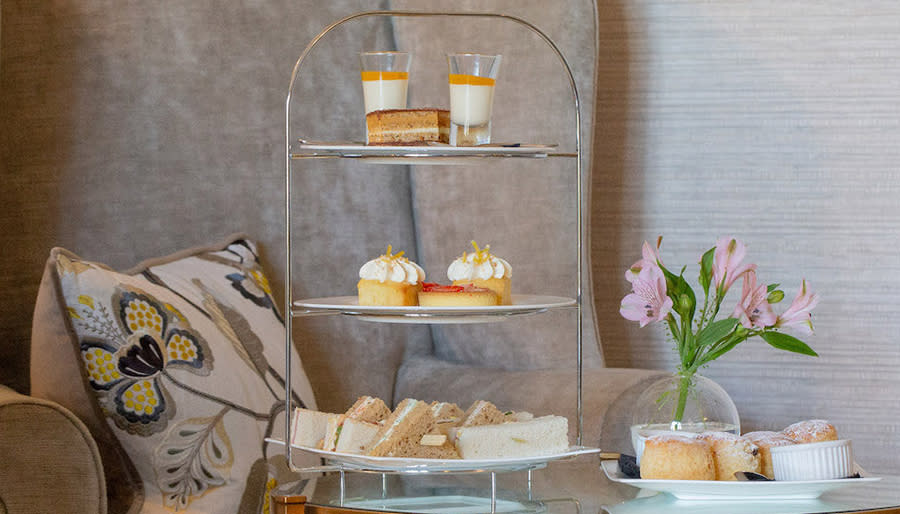 Three tier cake stand with afternoon tea goodies on