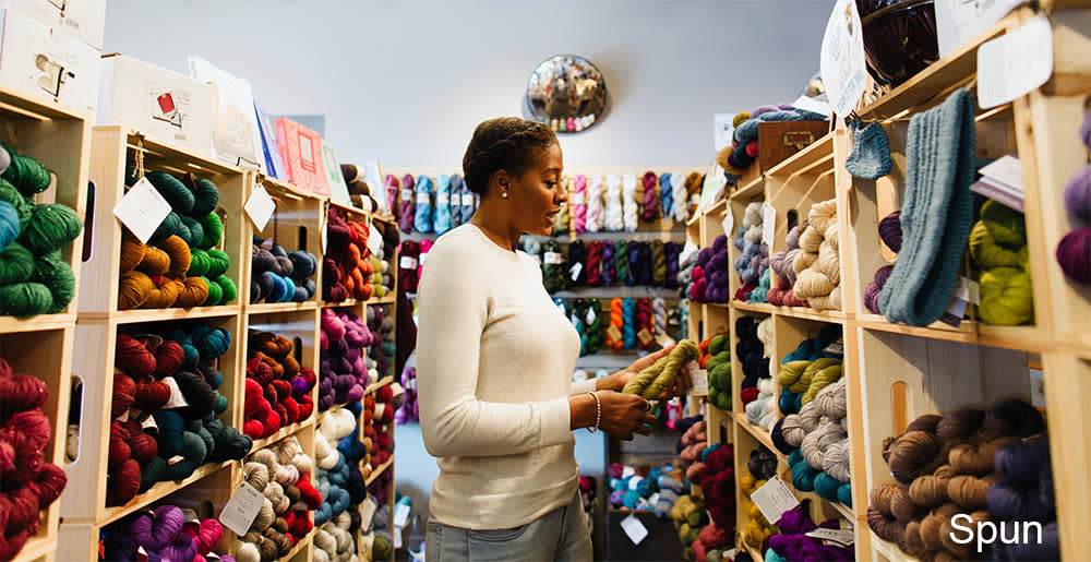 Woman browsing at yarn at Spun
