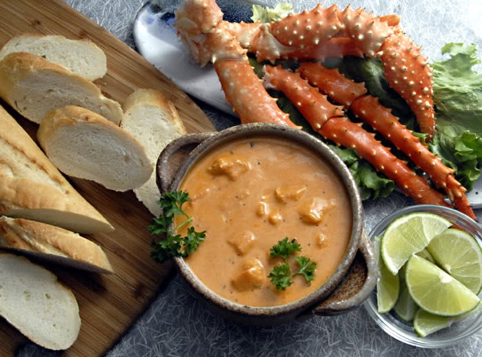 A spread of delicious, local Juneau foods including crab, chowder, and bread.