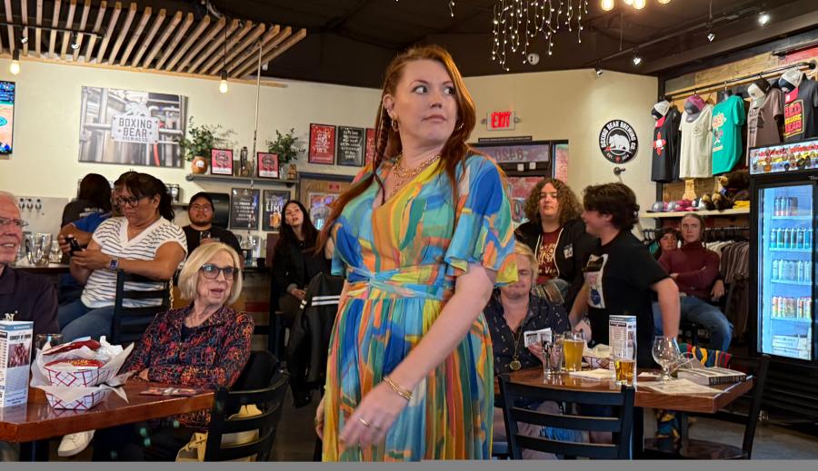 Duke City Repertory Theatre Company Member Evening Star Barron performs at a brewery during a performance of "Comedy of Errors" to packed tables of audience members.