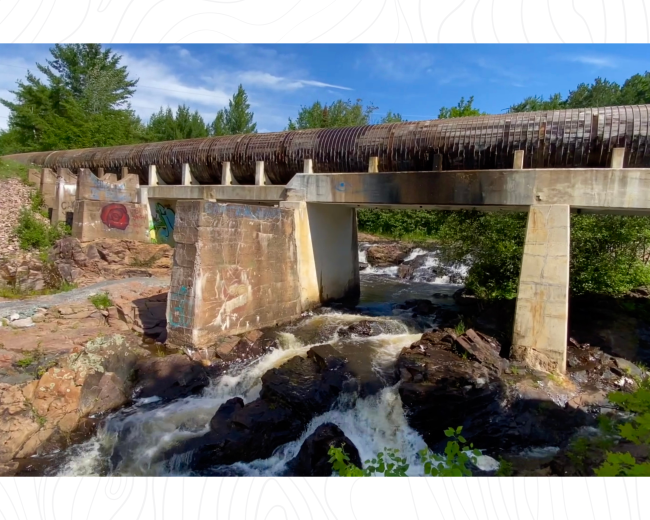 Concrete pillars support an old water pipe over Wright St Falls