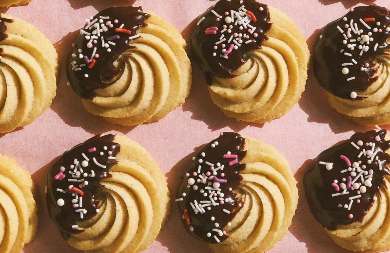 Chocolate dipped cookies with pink & white sprinkles from Rainbow Bakery