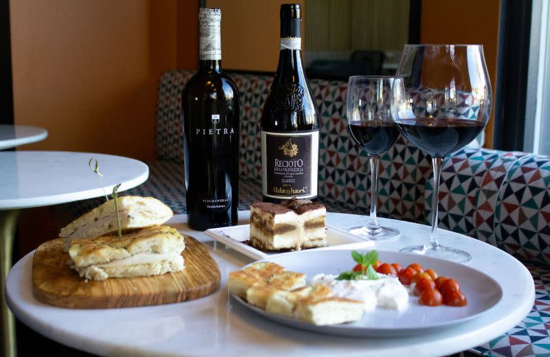 Plate of food and wine in two glasses at Sottovoce cafe in Palm Springs