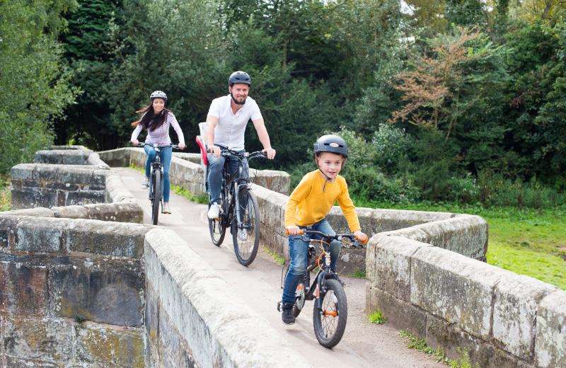 family bike ride across historic bridge