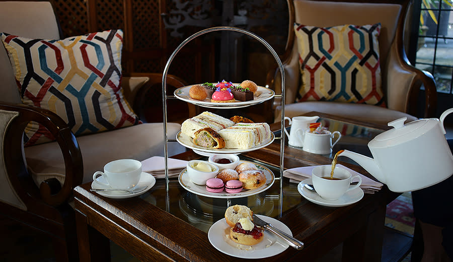 Traditional three tier cake stand with delicious looking afternoon tea at Whatley Manor